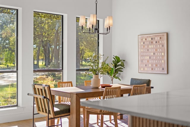 dining area featuring hardwood / wood-style floors and a chandelier