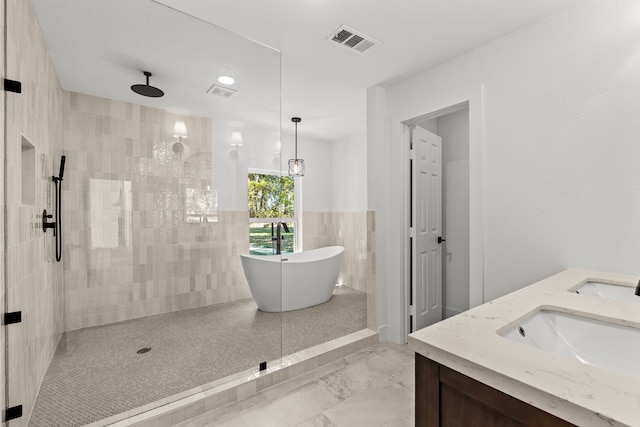 bathroom with vanity and independent shower and bath