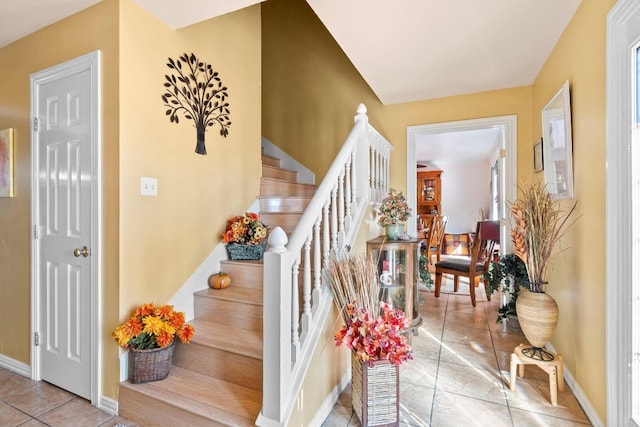 stairway featuring light tile floors