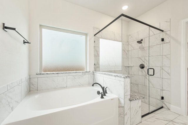 bathroom with a stall shower, marble finish floor, a garden tub, and recessed lighting