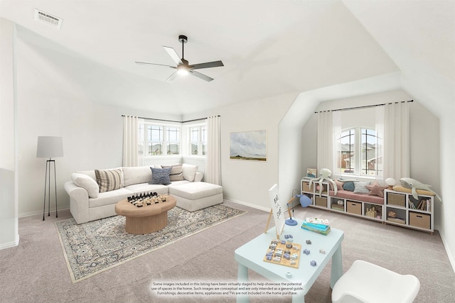 living area with vaulted ceiling, visible vents, carpet flooring, and a wealth of natural light