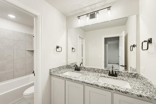 full bathroom featuring double vanity,  shower combination, a sink, and toilet