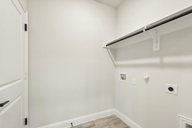 laundry room featuring hookup for a washing machine, hookup for a gas dryer, hookup for an electric dryer, laundry area, and light wood-type flooring