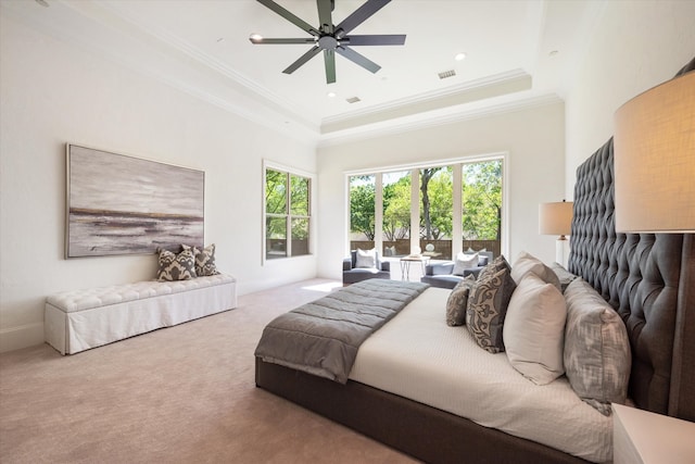 carpeted bedroom featuring ceiling fan, a raised ceiling, and ornamental molding