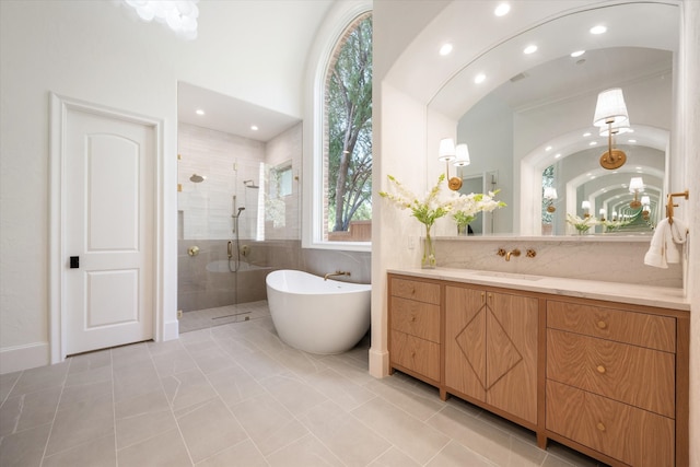 bathroom with vanity, shower with separate bathtub, and tile patterned floors