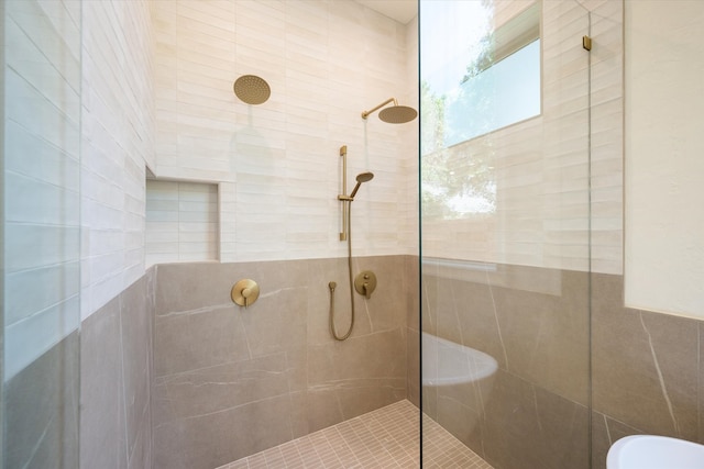 bathroom featuring tile walls and tiled shower