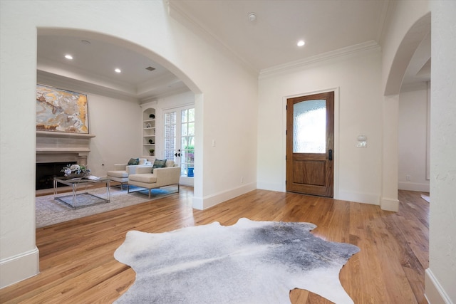 entrance foyer featuring light hardwood / wood-style floors and ornamental molding