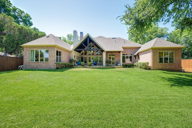 rear view of house with a lawn