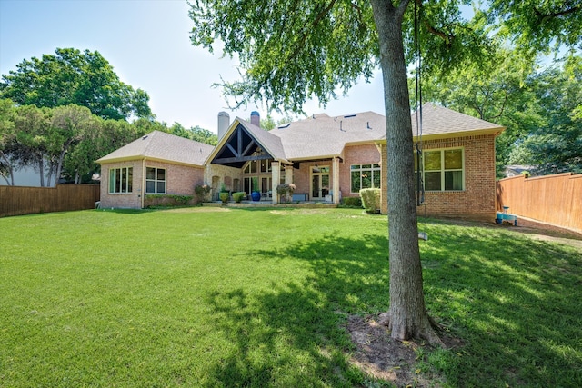 back of house with a lawn