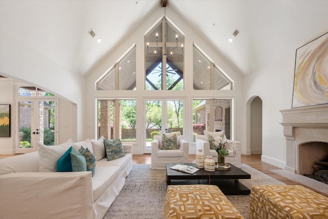 living room with french doors, hardwood / wood-style flooring, and high vaulted ceiling