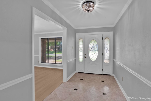 foyer entrance featuring crown molding and light tile patterned floors