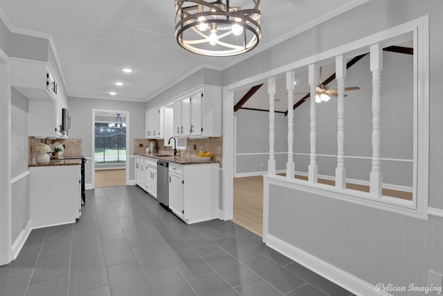 kitchen featuring sink, white cabinetry, crown molding, stainless steel appliances, and decorative backsplash