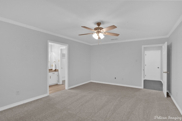 empty room featuring light carpet, crown molding, and ceiling fan