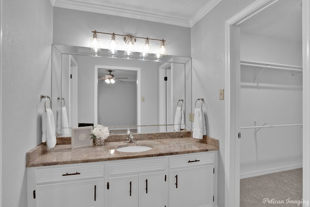 bathroom with ornamental molding, vanity, and ceiling fan