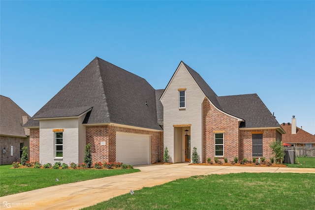 view of front facade featuring a shingled roof, a front lawn, concrete driveway, and brick siding