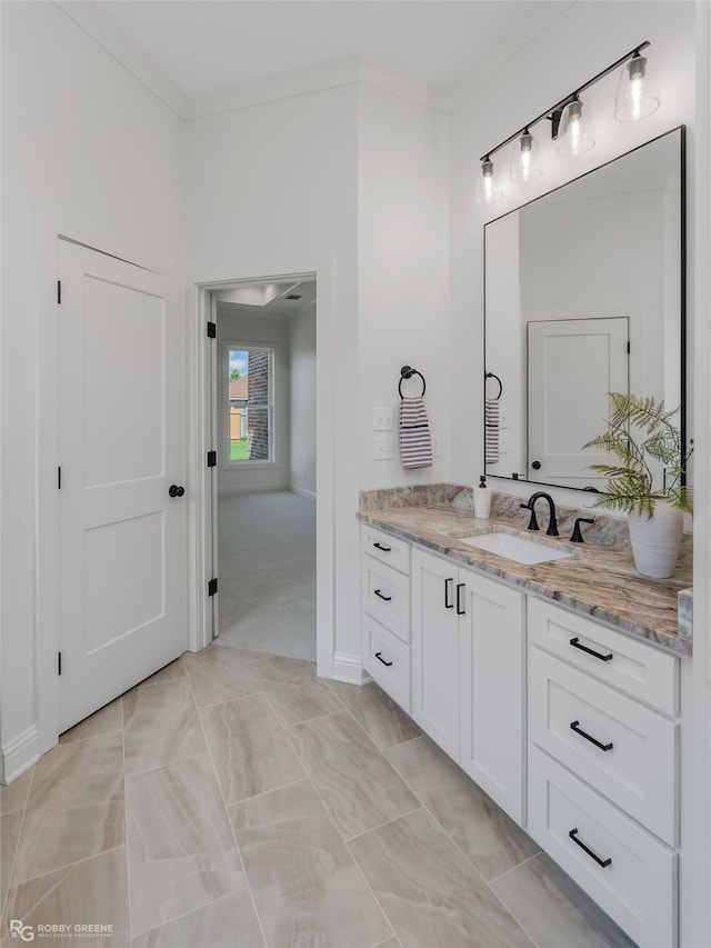 bathroom featuring vanity, crown molding, and tile patterned floors