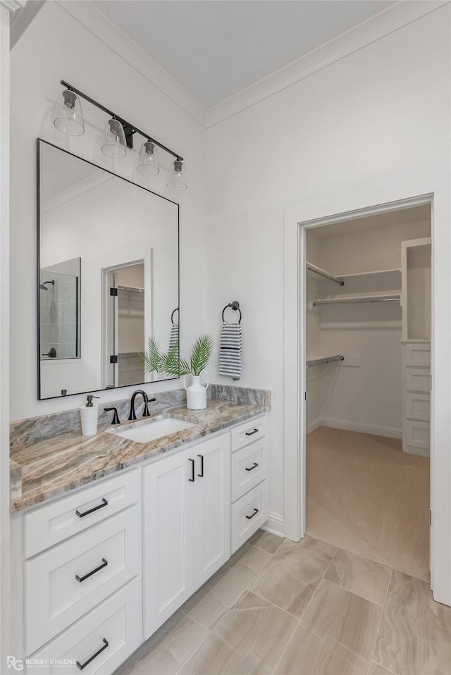 bathroom with tile patterned floors, crown molding, and vanity