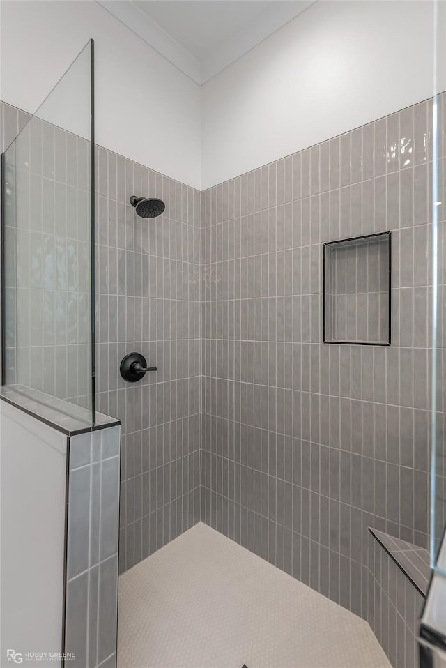 full bathroom featuring crown molding and a walk in shower