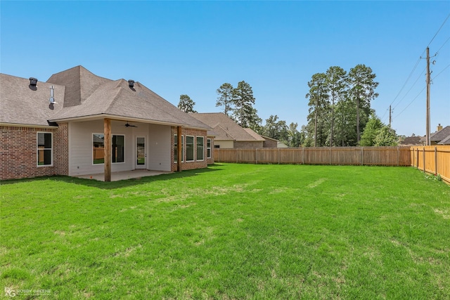 view of yard featuring a fenced backyard, ceiling fan, and a patio