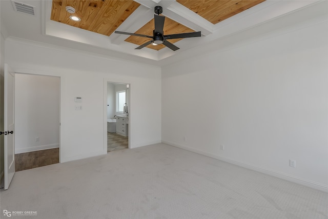 carpeted spare room with wood ceiling, a tray ceiling, ceiling fan, and coffered ceiling