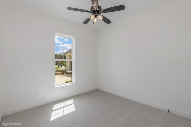 carpeted spare room featuring a healthy amount of sunlight and ceiling fan