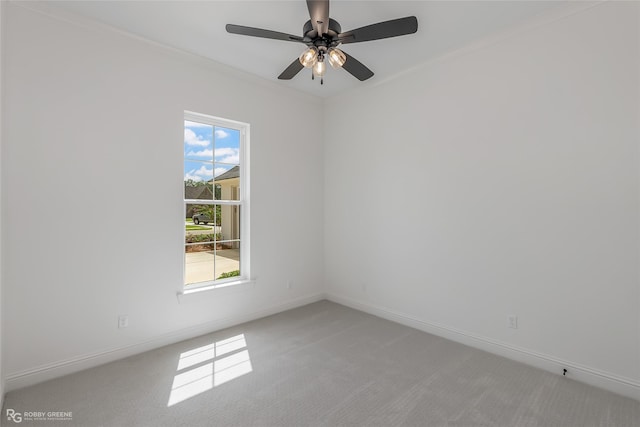 spare room featuring carpet floors, ceiling fan, and baseboards