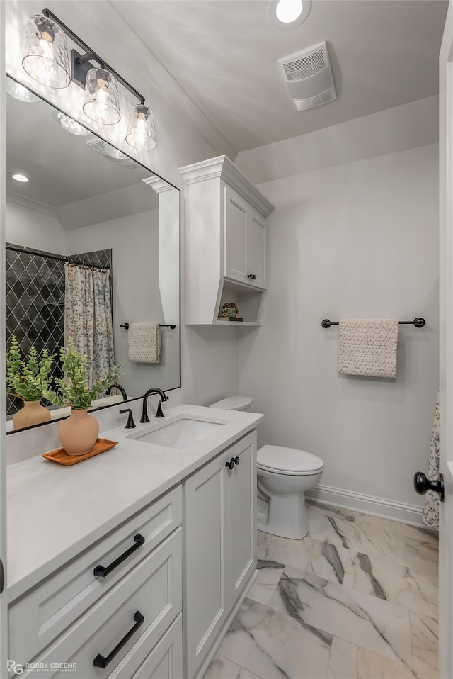 bathroom with vanity, toilet, and tile patterned floors