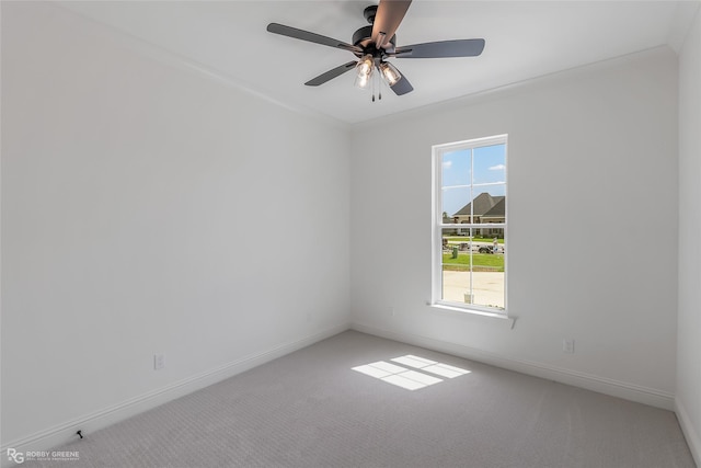 unfurnished room with carpet, baseboards, and a ceiling fan