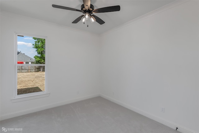 unfurnished room featuring carpet flooring, a healthy amount of sunlight, crown molding, and ceiling fan