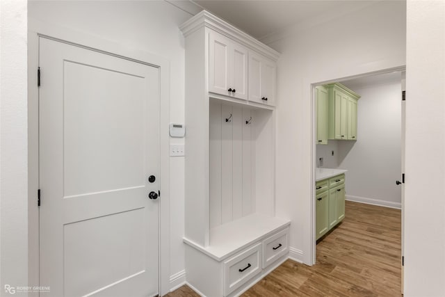 mudroom with baseboards and light wood finished floors