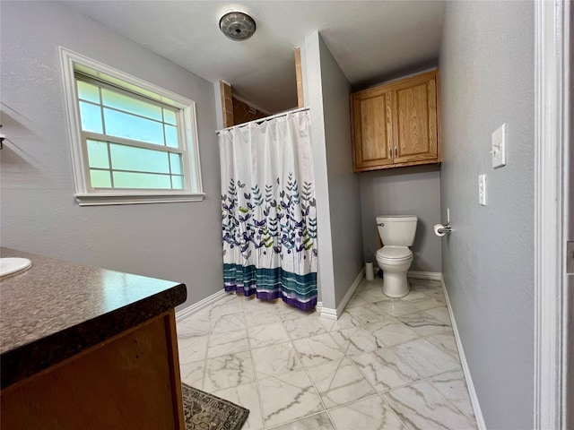 bathroom with toilet, tile floors, and vanity