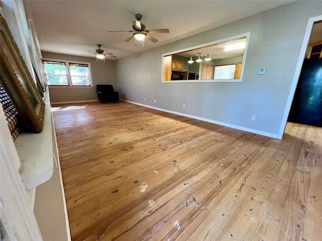 unfurnished living room with ceiling fan and light hardwood / wood-style flooring