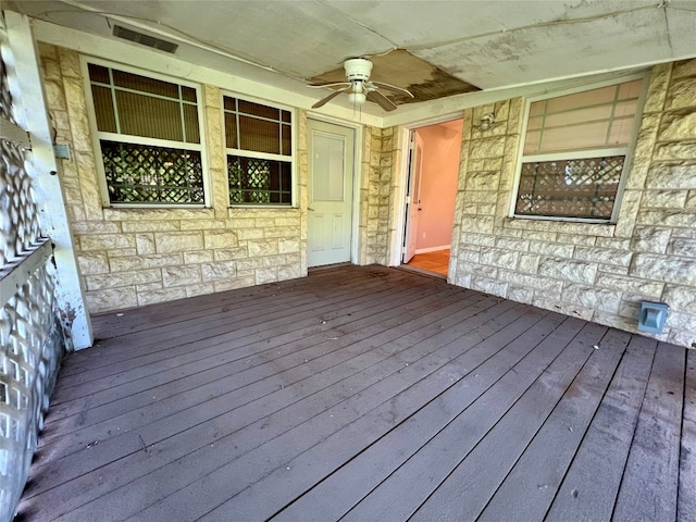 wooden terrace featuring ceiling fan