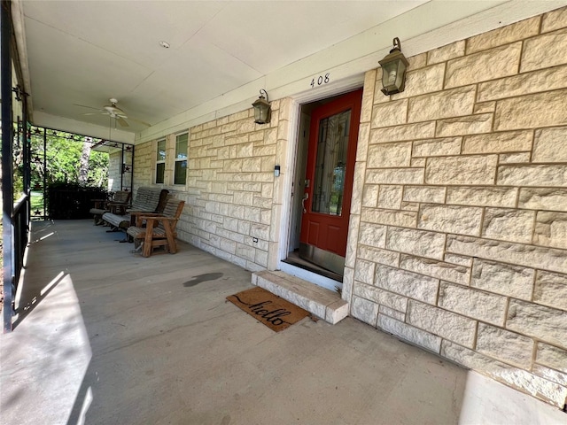 property entrance featuring ceiling fan and a porch