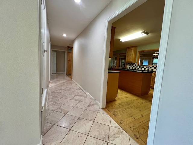 hall featuring light tile floors