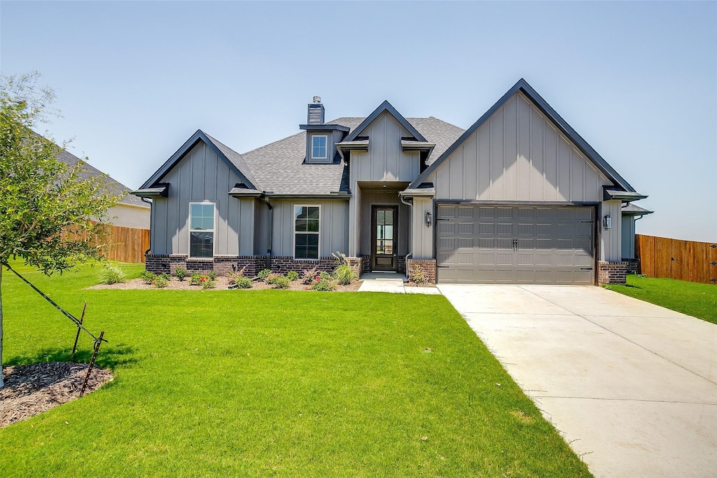 view of front of property featuring a front yard and a garage