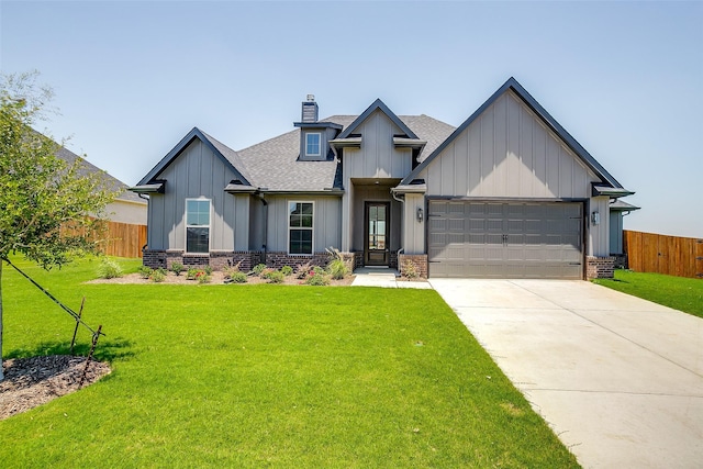 view of front of property featuring a front yard and a garage