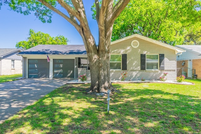 ranch-style house featuring a front yard and a garage