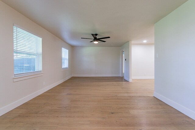 empty room featuring ceiling fan and light hardwood / wood-style floors