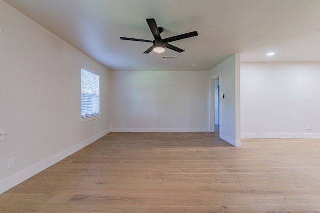 spare room with ceiling fan and light wood-type flooring