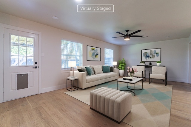 living room featuring light hardwood / wood-style flooring and ceiling fan