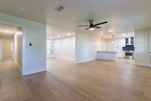 unfurnished living room with light hardwood / wood-style floors and ceiling fan