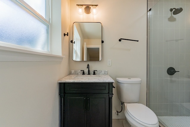 bathroom with a wealth of natural light, toilet, a shower with door, and oversized vanity