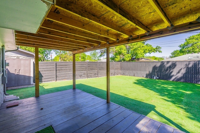 deck featuring a shed and a yard