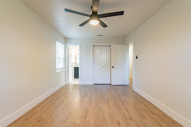 unfurnished bedroom featuring light hardwood / wood-style floors, a closet, and ceiling fan