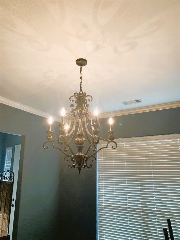 interior details featuring a chandelier and ornamental molding