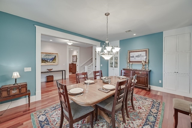 dining room with a chandelier and hardwood / wood-style flooring