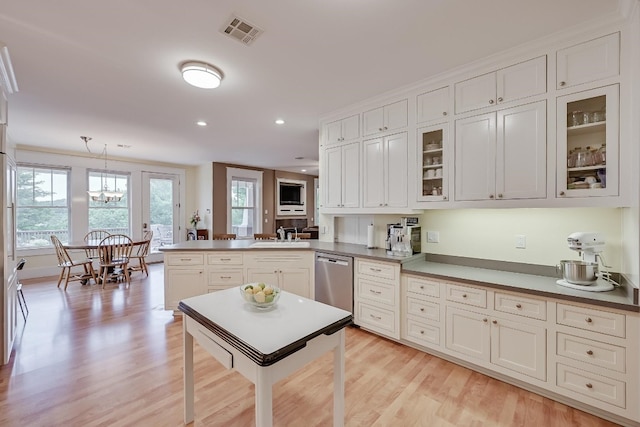 kitchen with kitchen peninsula, light hardwood / wood-style flooring, white cabinetry, pendant lighting, and stainless steel dishwasher