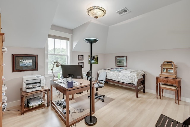 office space with vaulted ceiling and light hardwood / wood-style floors