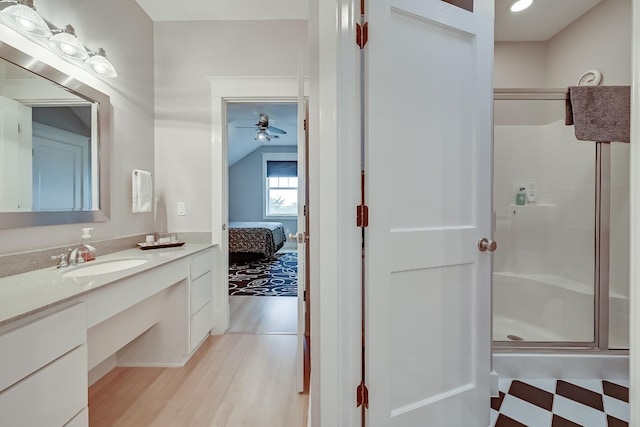 bathroom with walk in shower, large vanity, ceiling fan, lofted ceiling, and tile floors